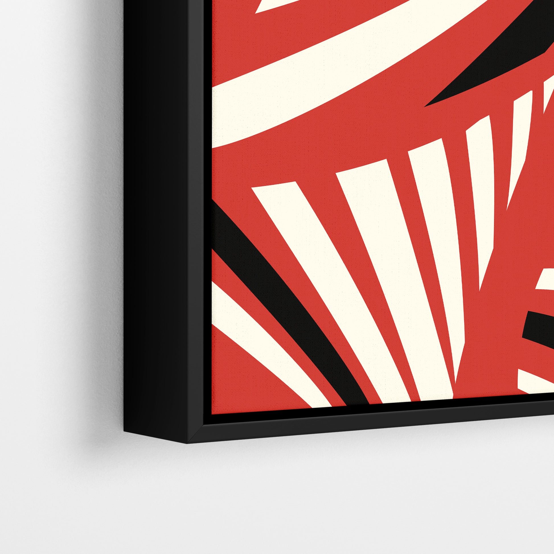 Close-up detail of Charleston Red framed Art Deco print - radiating geometric forms with tropical foliage in bold red three-tone palette