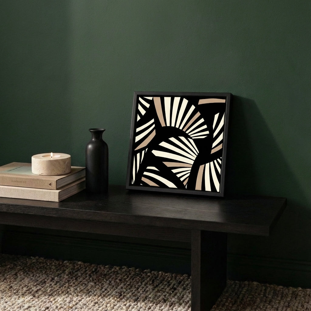 Framed art deco Black and Cream abstract art piece on a dark wooden table against a green wall.