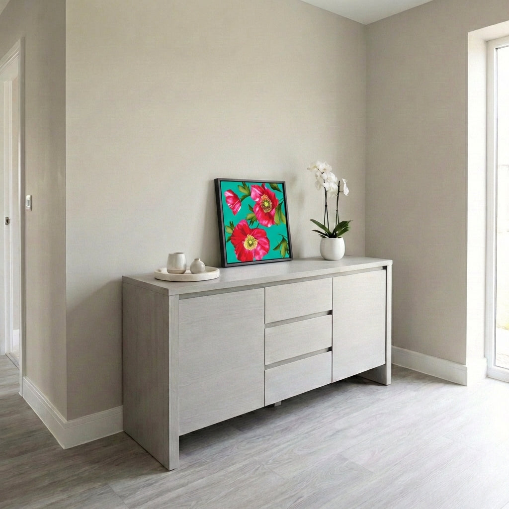 Light grey sideboard with Isla Turquoise resting on a beige walls and wooden flooring.
