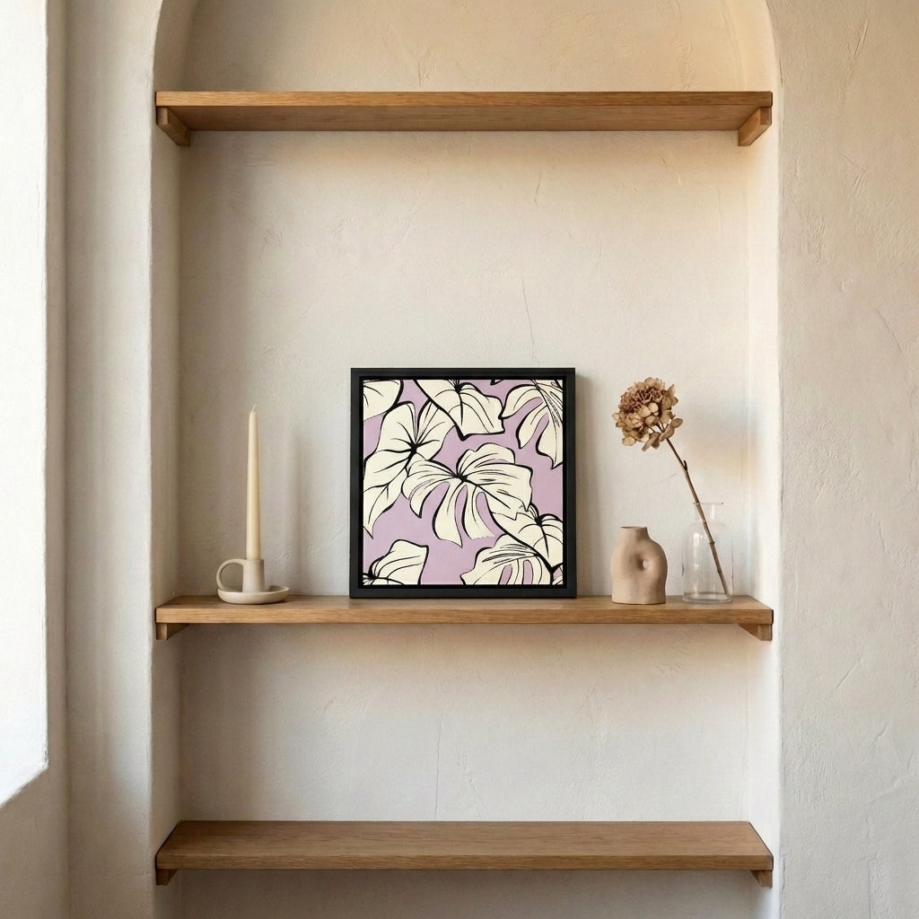 Framed Kai Lilac artwork with leaf design on a wooden shelf against a beige wall.