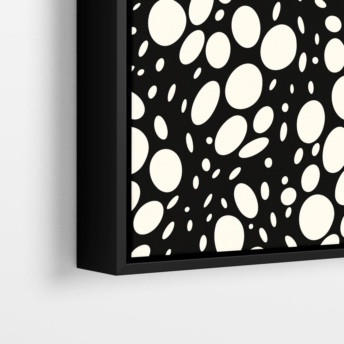 Close-up detail of Spots black framed abstract print - hundreds of varied-size white oval shapes creating texture on black background