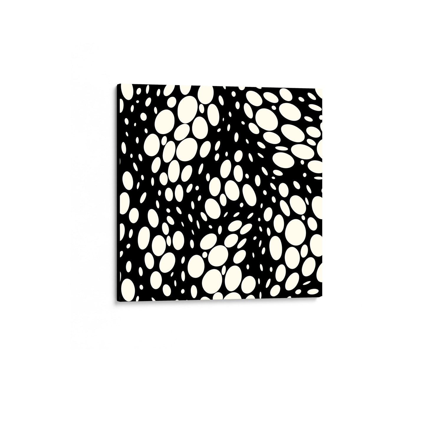 Spots black mini square abstract wall art angled view showing a canvas with dynamic organic polka dot design with scattered cream spot