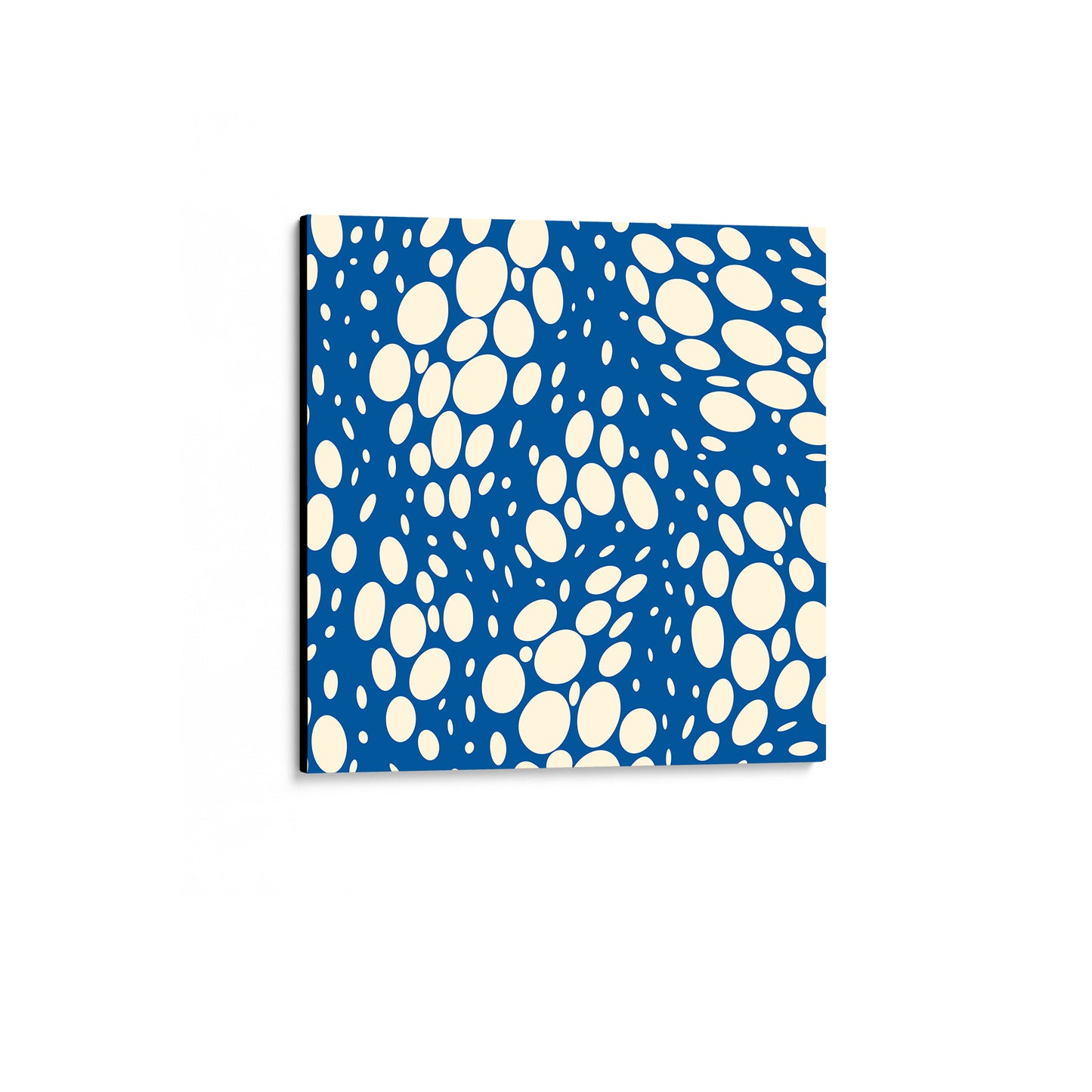 Spots Blue mini abstract wall art angled view showing an unframed canvas with dynamic organic polka dot design with scattered white spots