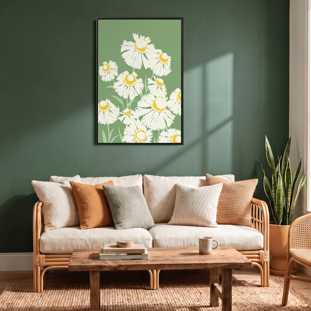 A black framed Margarite Meadow Green wall art print featuring white daisies with yellow centre on a muted green background, displayed above a light wood sofa in a styled living room with green walls, neutral pillows, and a wooden coffee table.
