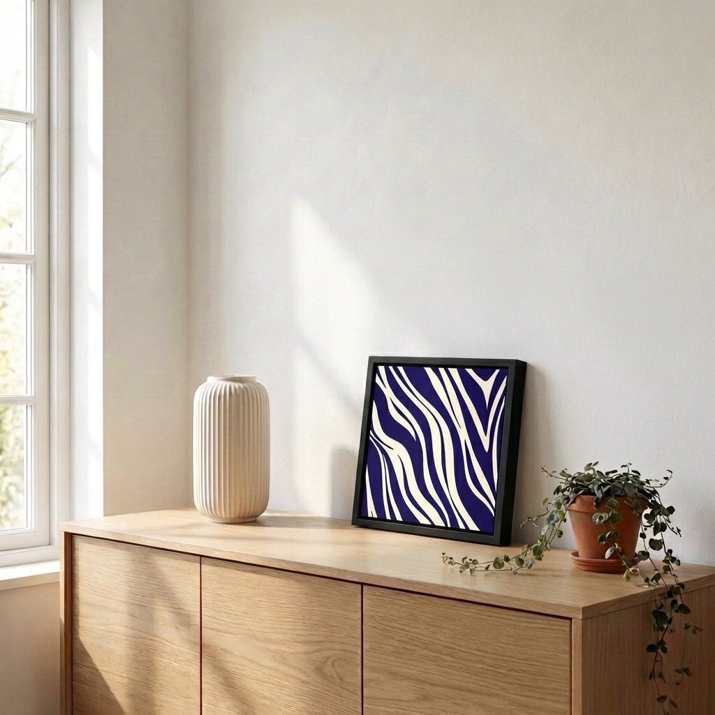 Paloma Navy framed artwork with zebra pattern on a wooden sideboard with decorative items.