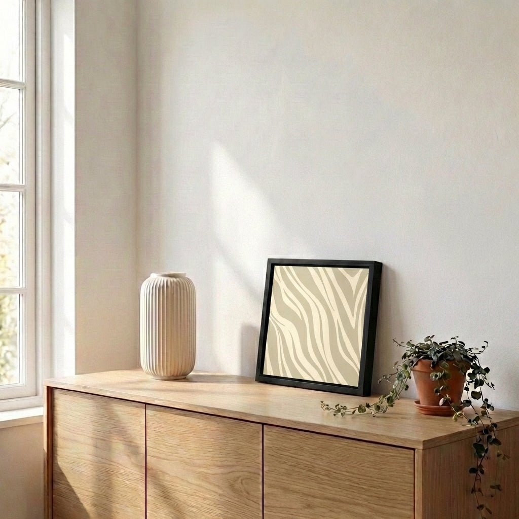 Wooden sideboard with decorative items including a vase, framed Paloma wall art, and potted plant against a light wall.