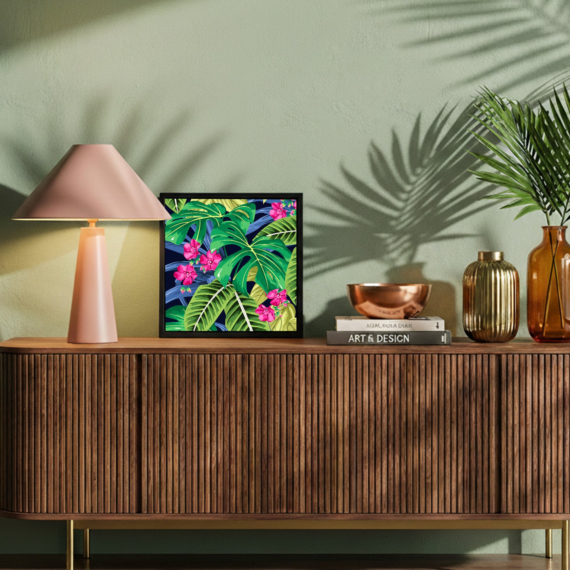 Decorative setup on a wooden console table with a lamp, framed Solana Pink Mini art, and decorative items