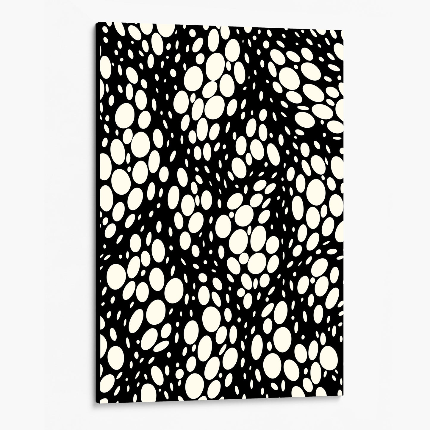Spots black abstract wall art angled view showing a canvas with dynamic organic polka dot design with scattered cream spots