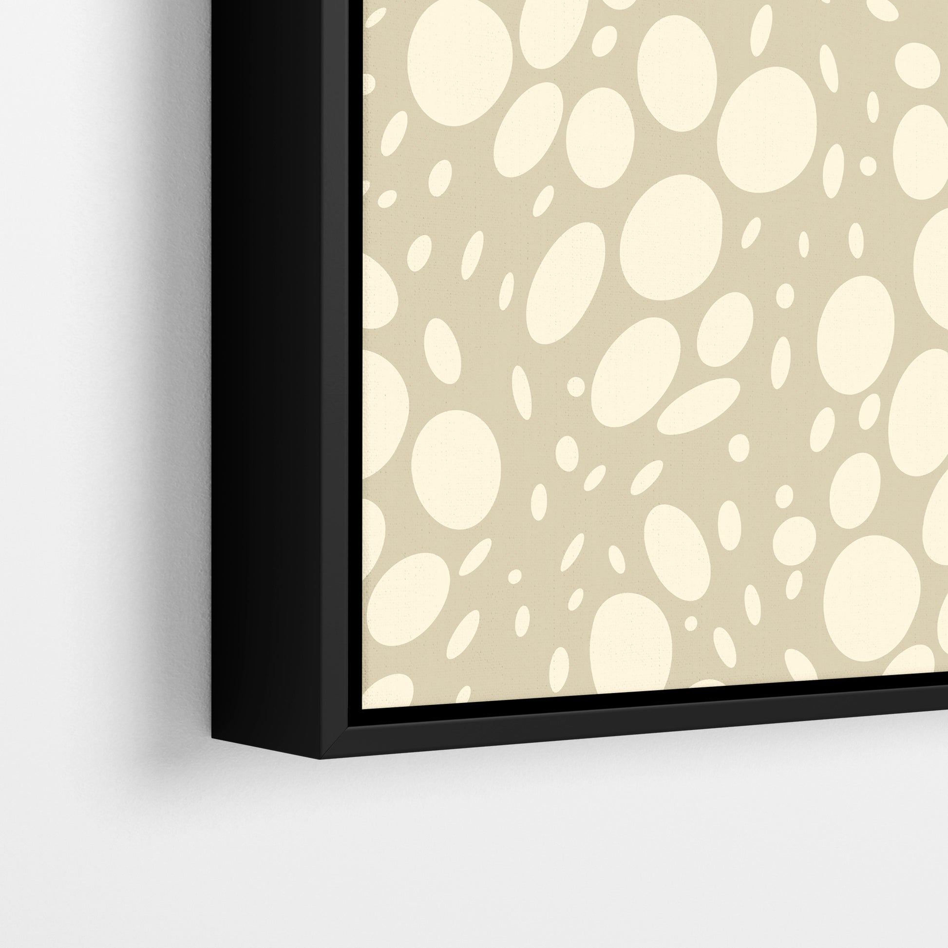 Close-up detail of Spots Stone framed abstract print - hundreds of varied-size cream oval shapes creating movement on coffee background