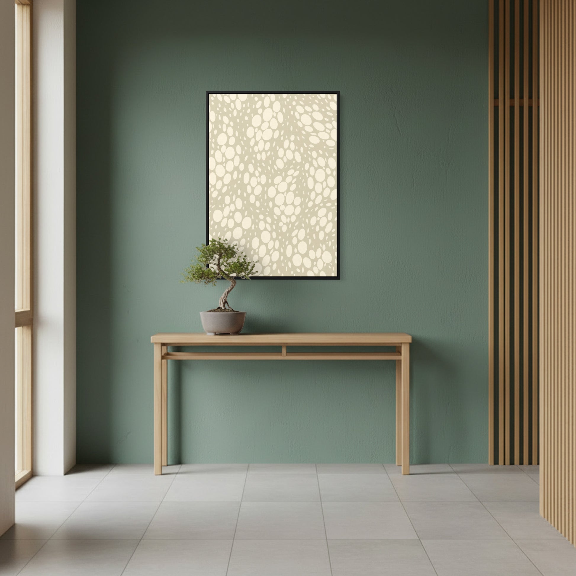 Minimalist interior with a wooden console table, potted plant, and framed lauren Stone artwork on a green wall.