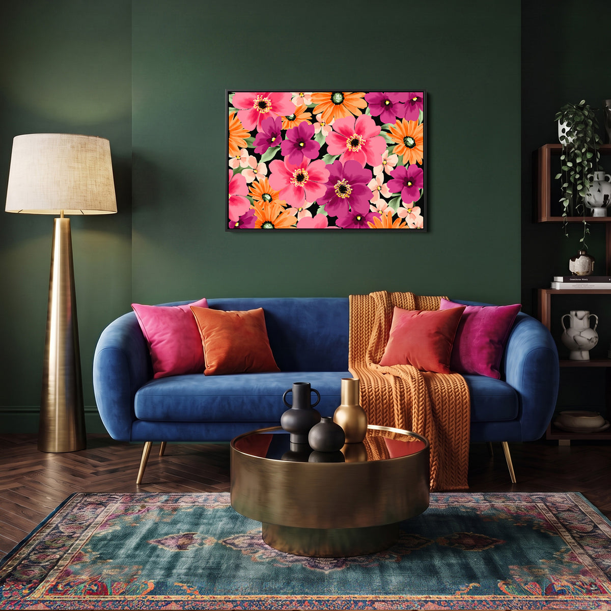 Sofia coral framed floral wall art print with bright pink, orange, and purple flowers hangs above a blue velvet sofa in a styled living room with a gold floor lamp, patterned rug, and decorative pillows.